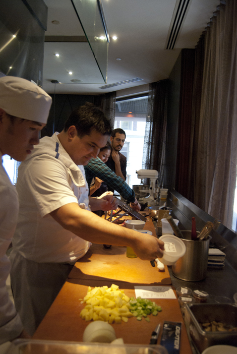 Chef Maximo demonstrates as Nick looks on pensively. 