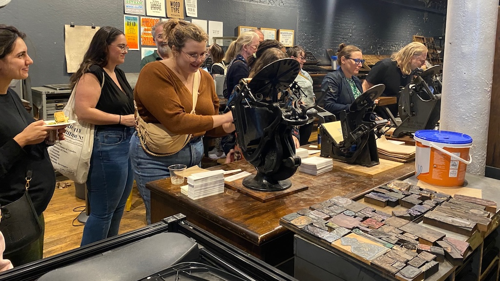 LM Live event attendees at Bowne & Co. using historic printmaking machines.