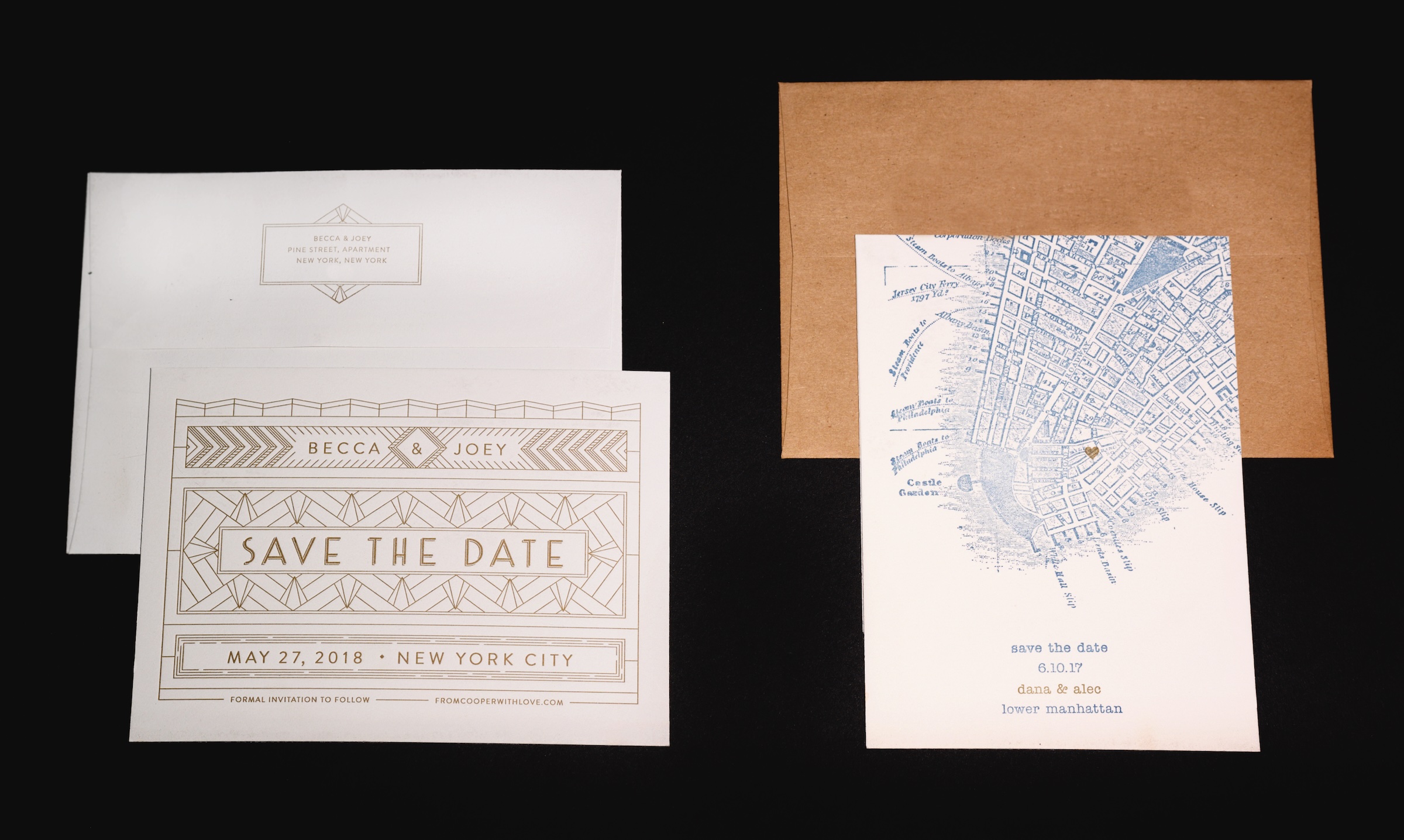 Two save-the-date invitations with envelopes on dark surface.