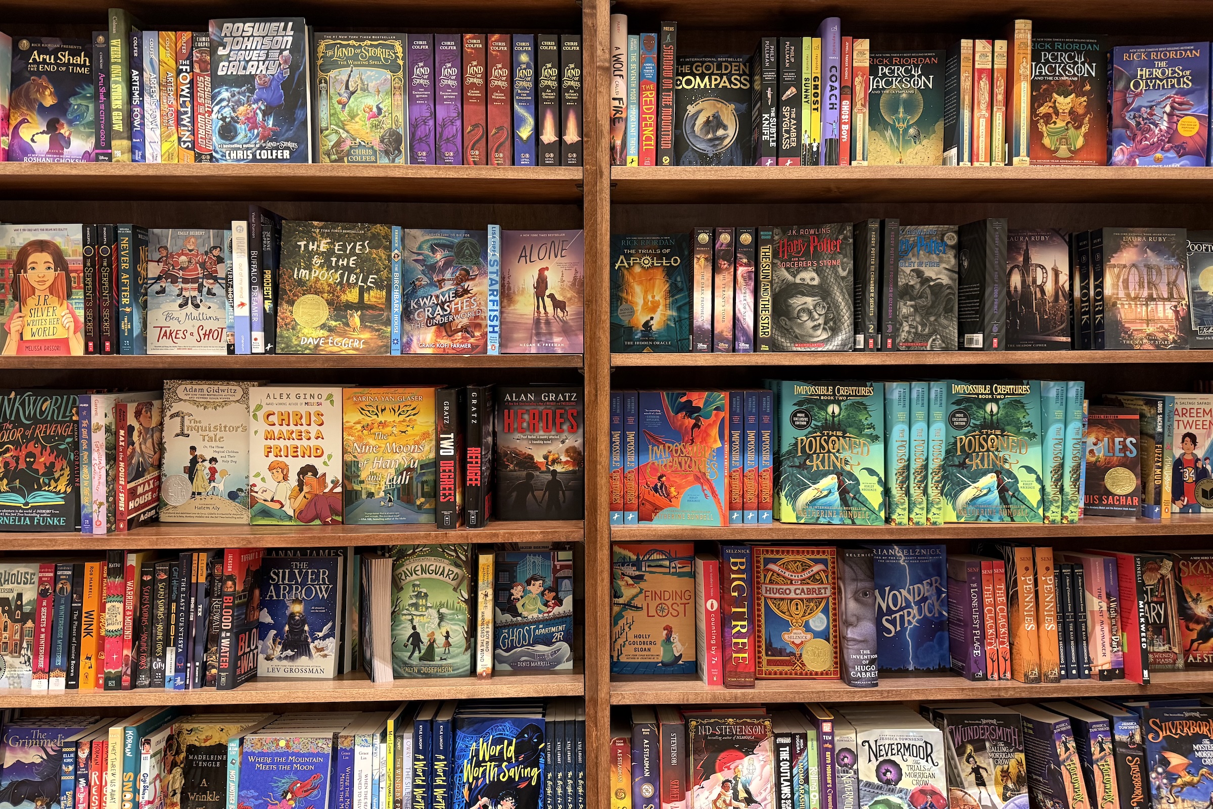 Two bookshelves with rows of colorful children's books.